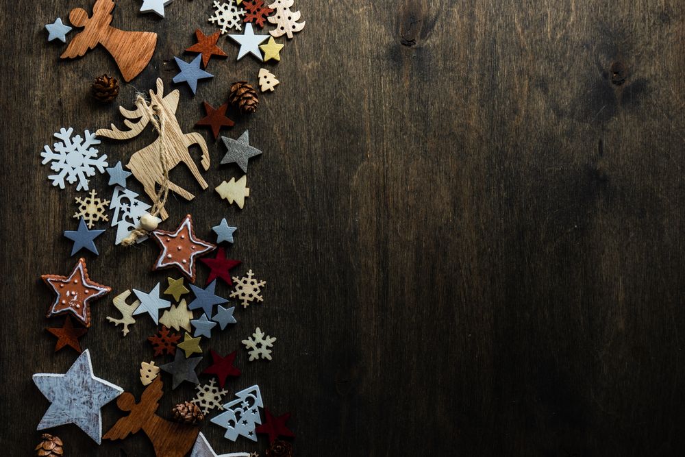 Top view of flat cut out Christmas ornaments along side of table