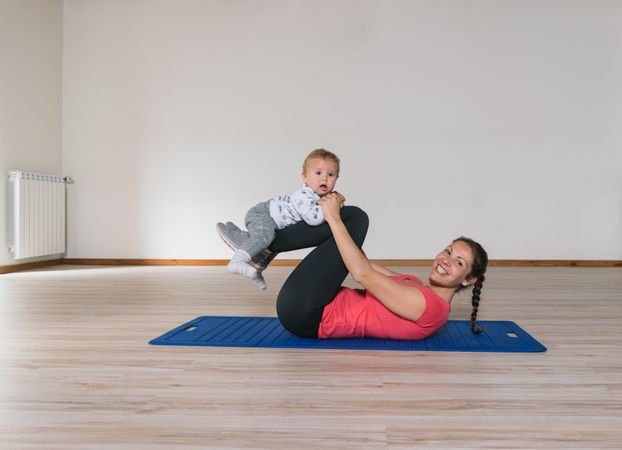 Mother exercising with baby in gym