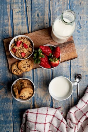 Glasses near fruits and cookies on table near napkin