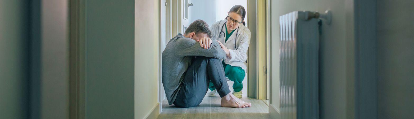 Doctor assisting and comforting to patient