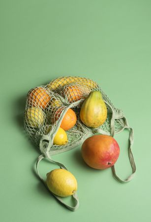 Ripe tropical fruits in a net shopping bag