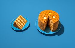 Medovik, honey layered cake, russian recipe, in bright light on a blue table