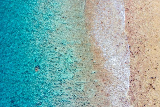 Aerial shot of clear beach waters in the Maldives