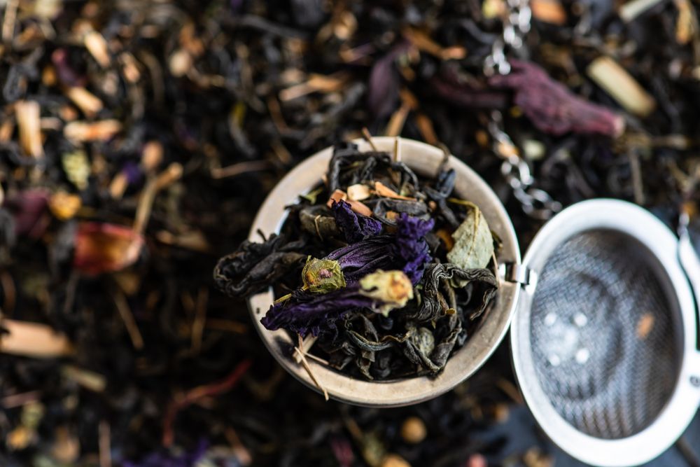Close up of floral tea in a metal mesh strainer