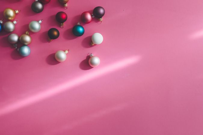 Christmas bauble decoration on shadowy pink background