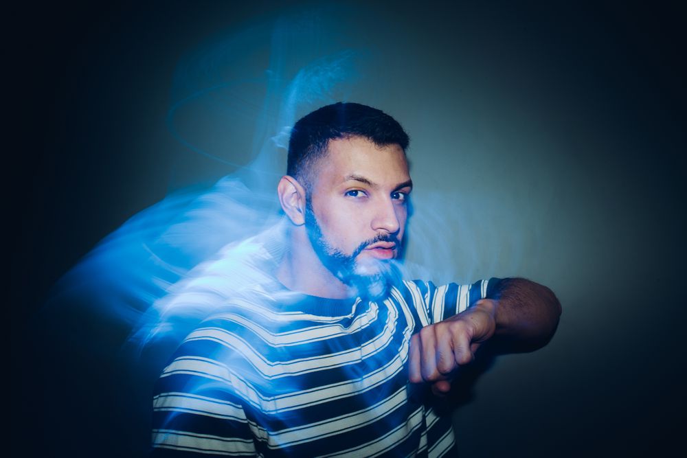 bearded man dancing in spotlight