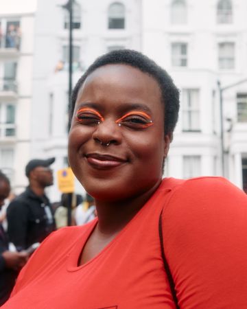 London, England, United Kingdom - August 28, 2022: Black woman outside with orange eye make up