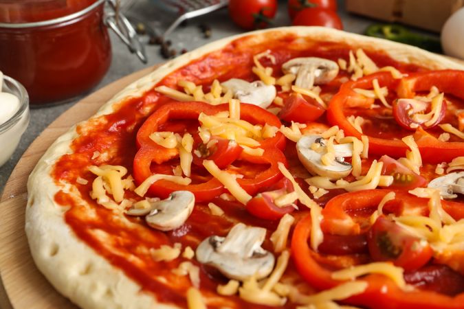 Concept for cooking pizza with ingredients on gray table