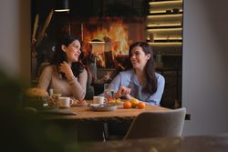 Women talking and eating at home
