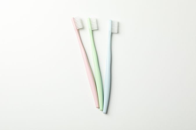 Toothbrushes on light background, top view. Dental care