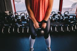 Woman standing with kettlebell at the gym