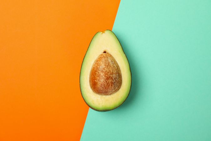 Ripe fresh avocado on two tone background, top view