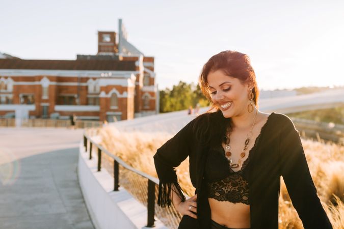 Trendy female standing on urban background