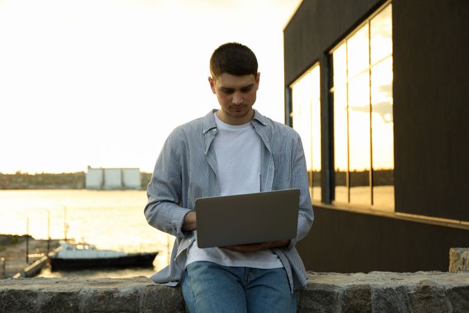 Young man working in a laptop outdoor. Freelancer
