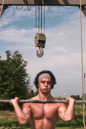man with barbell in outdoor gym