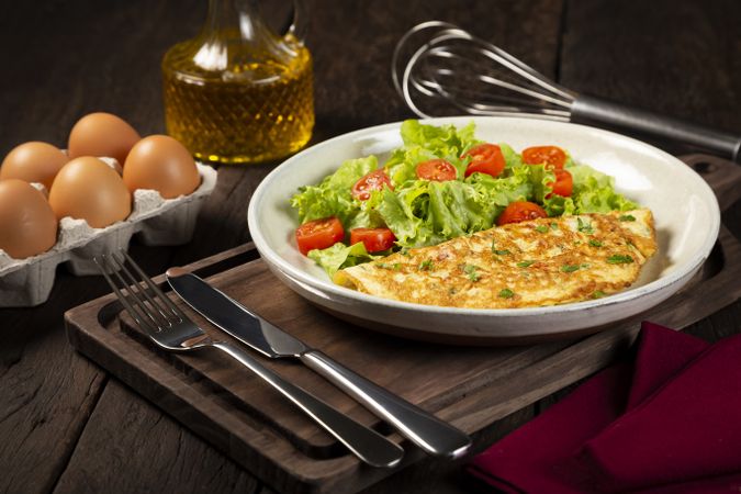 Omelet with cheese and lettuce and tomato salad.