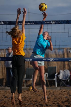 Two girls playing volleyball