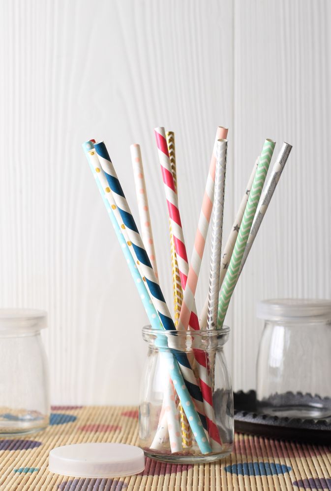 Colorful paper straws on wooden background