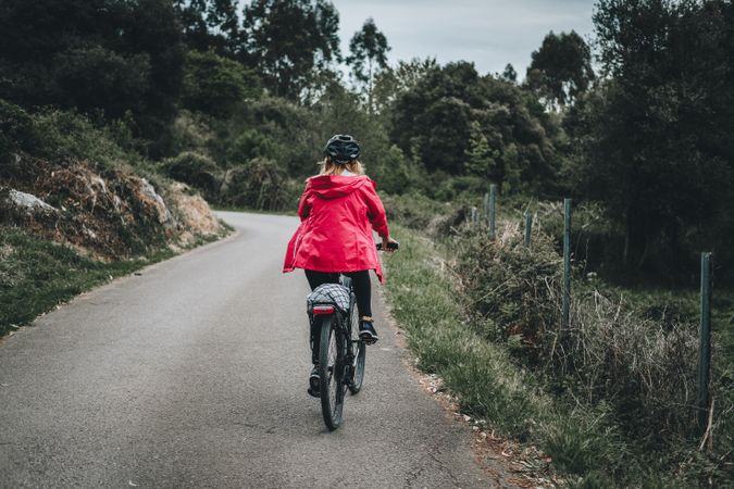 Female riding bicycle in countryside road