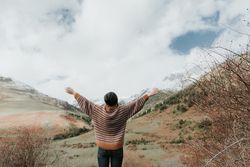 Young woman standing in a beautiful landscape between mountains