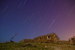 Ancient stone building on hill and wonderful sky