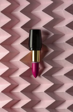 Lipstick on raised pink chevron. Product and make up concept