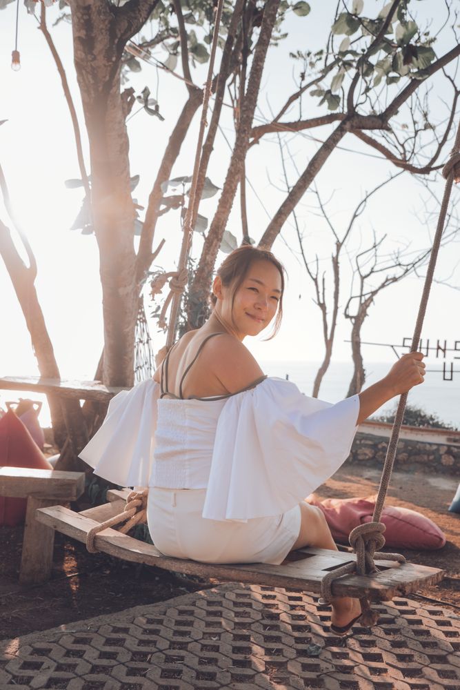 Young woman sitting on swing