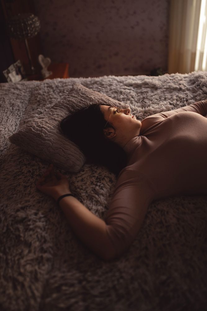 Young woman lying on bed