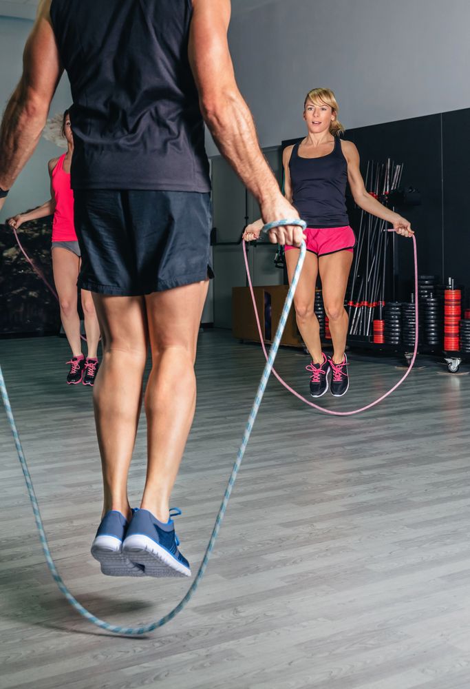 People jumping rope in fitness class