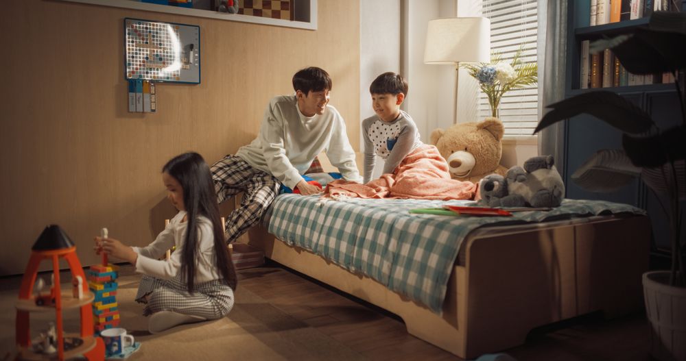 Father Enters Children's Room to Wake Up His Adorable Son, While Cute Little Daughter is Already Playing with Her Toys.