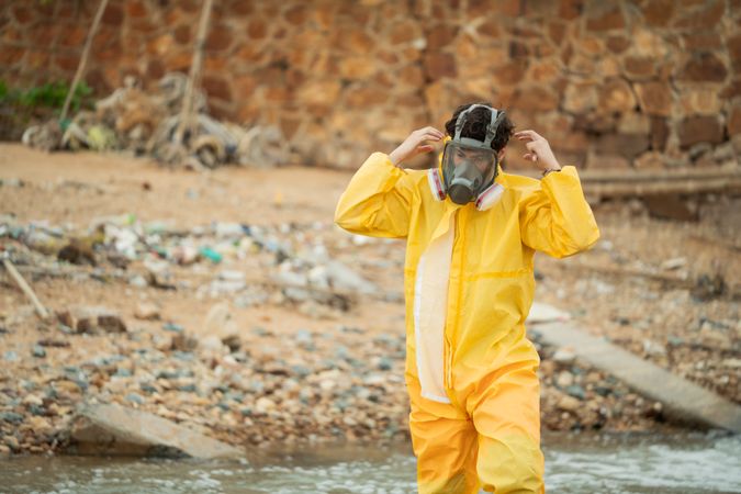 Environment scientist wearing chemical protective cloth and mask before working