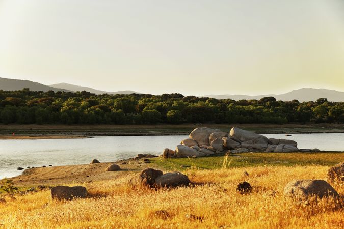 Picturesque view of lake with countryside route, fir forest and hills in Valmayor lake Spain