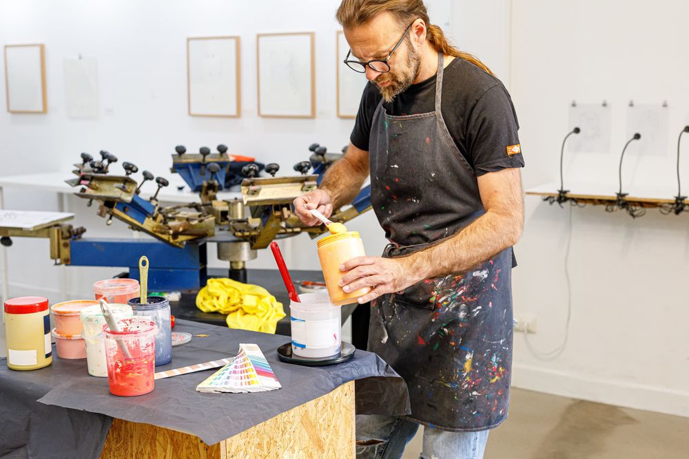 Mature male artist preparing paints