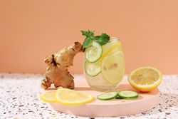 Infused iced water with lemon, ginger and cucumber garnish