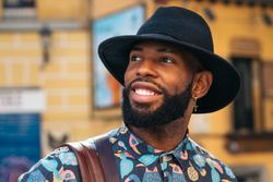 Stylish Black man walking on the city street