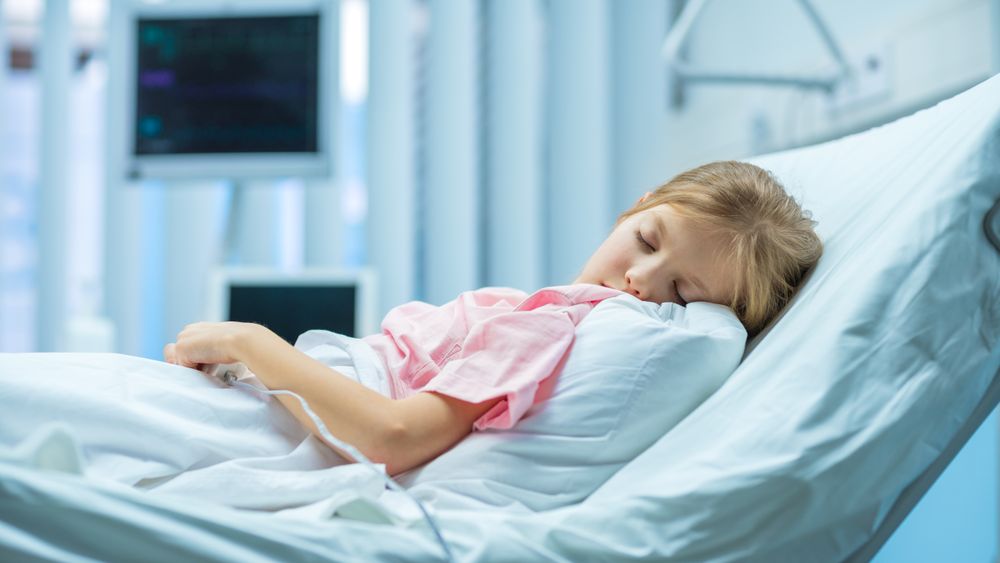 Sick Little Girl Lying and Sleeping on a Bed In the Hospital
