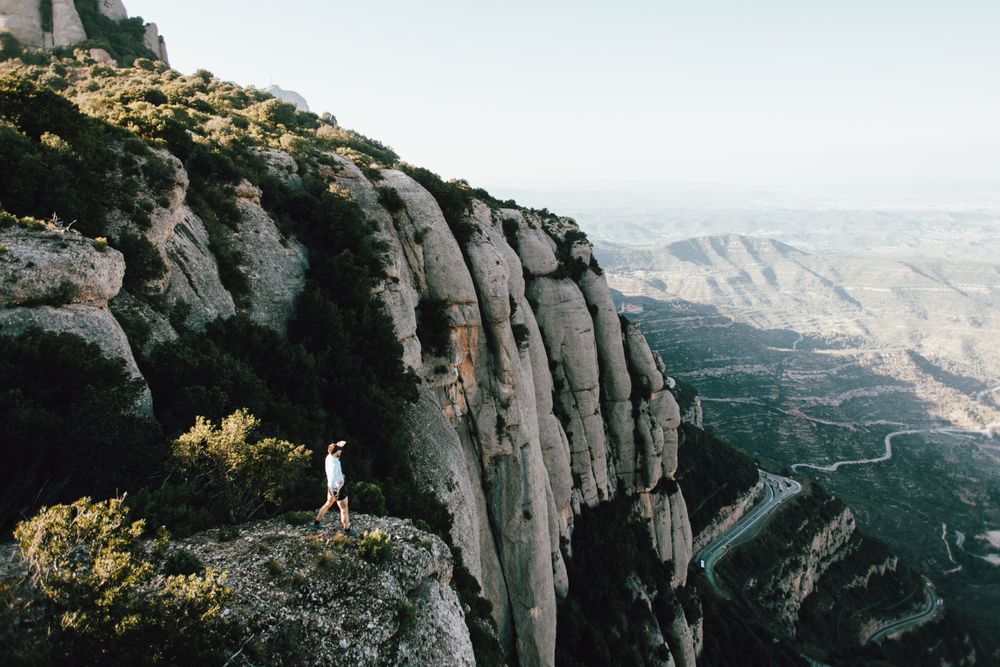 Athlete on cliff looking over road