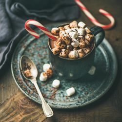 Marshmallows topping of festive hot drink in mug, square crop