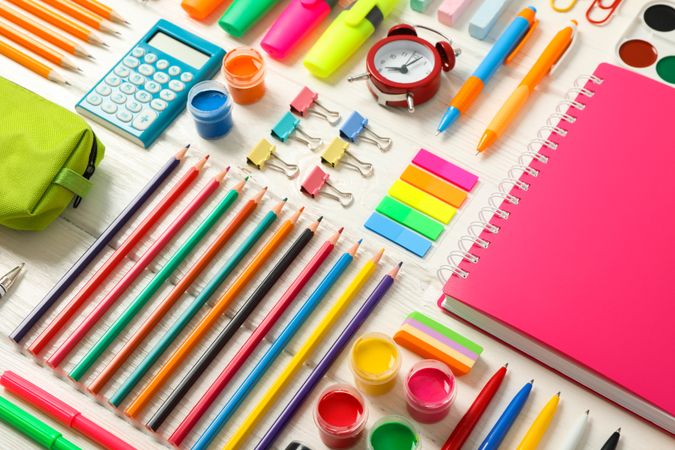Flat lay composition with school supplies on wooden background