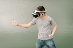 Young teenager with virtual reality glasses outdoors