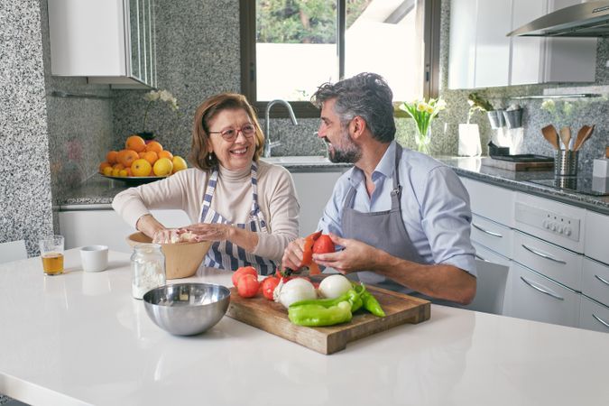 Mother and son cooking together at table