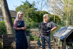 Two older women chatting in the garden