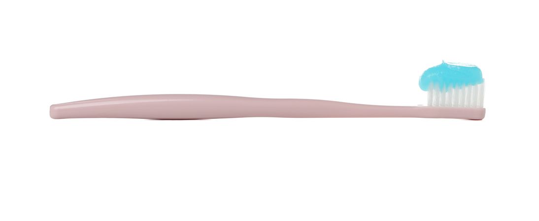 Toothbrush with toothpaste isolated on light background