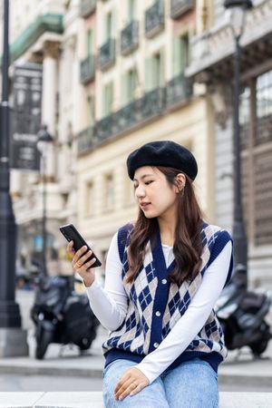 Young Asian woman using smartphone in the city