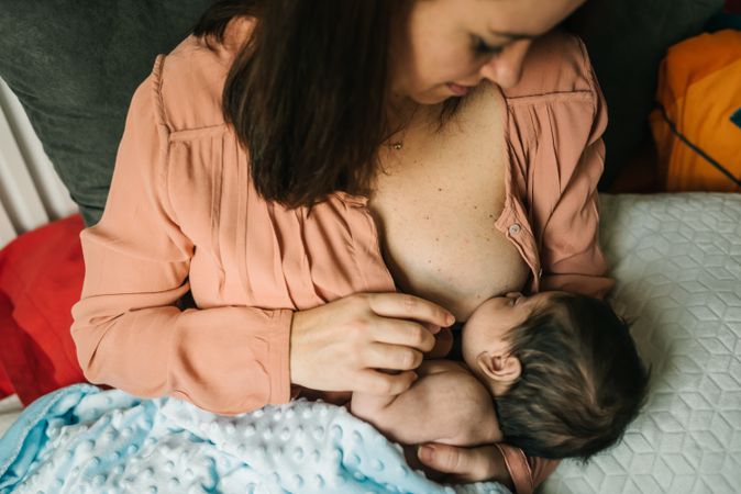 Mom breastfeeding at home