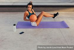 Female doing core workout with ball outdoors 4mdvQ5