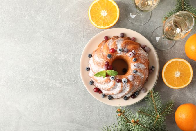 Cake with powder sugar and berries on grey table. Happy new year concept