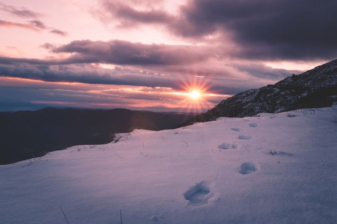Sun setting over snowy mountains
