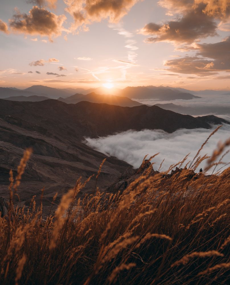 Mountains above clouds at golden hour