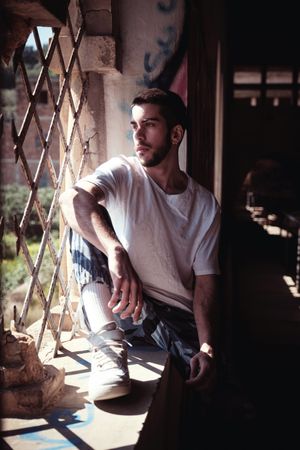 Man sitting in abandoned building